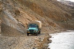 33 Truck Driving On Narrow Road Next To Chongphu Chu River On Drive To Kharta Tibet.jpg